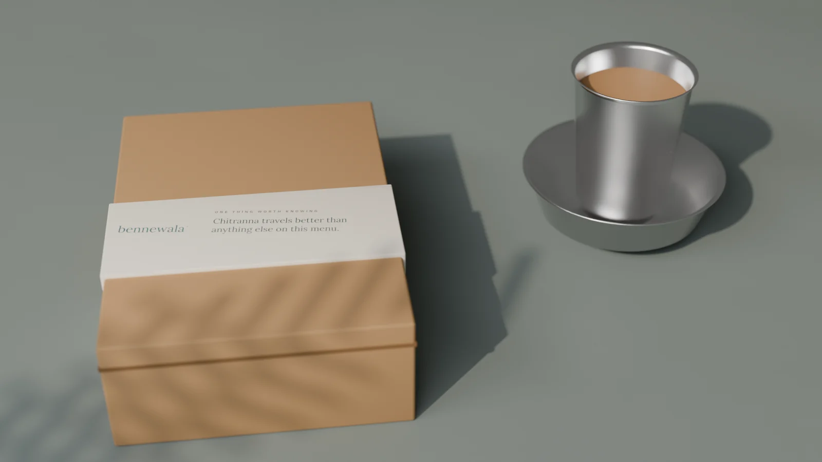 bennewala parcel in kraft with a printed sleeve, beside a steel filter coffee davara