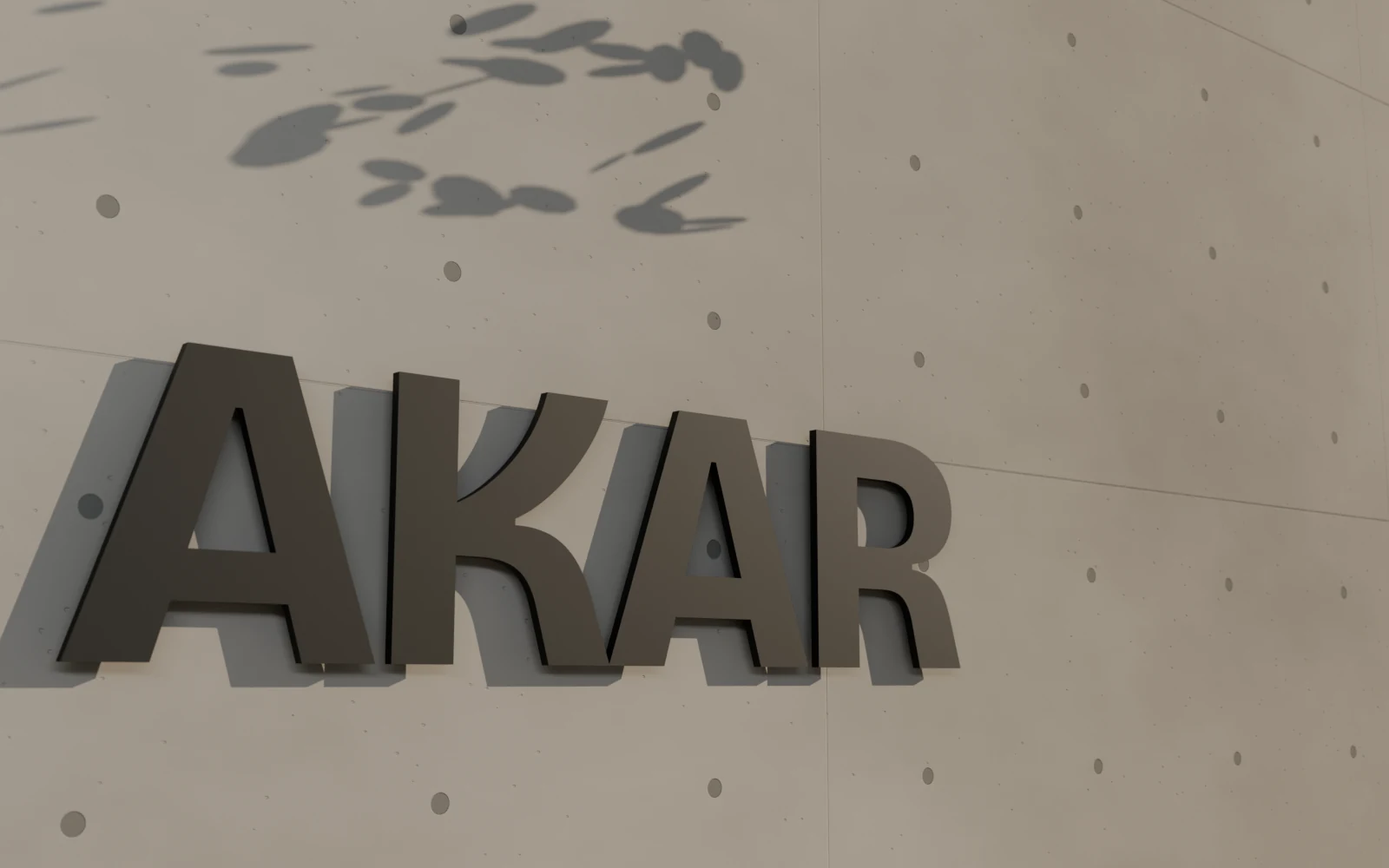 AKAR in dark metal letters on a fair-faced concrete wall