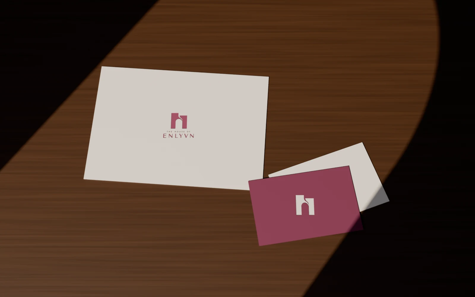 The House of Enlyvn stationery in plum and ivory, in arch-shaped light