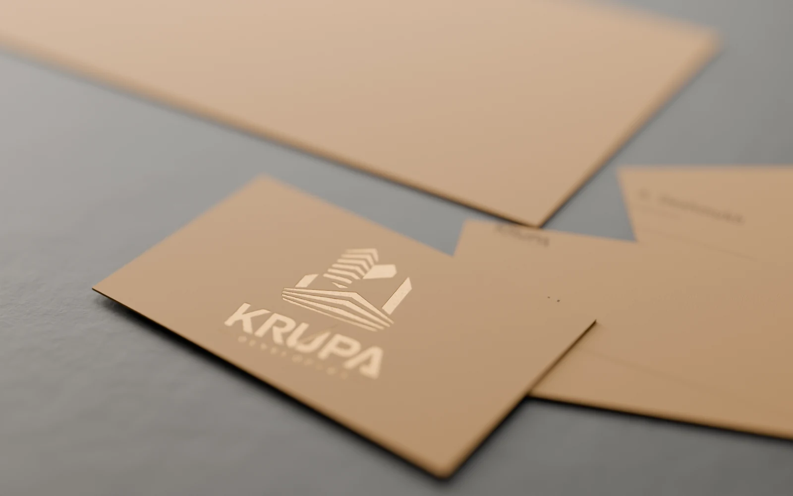 KRUPA Developers business cards with bronze foil on kraft, envelope behind